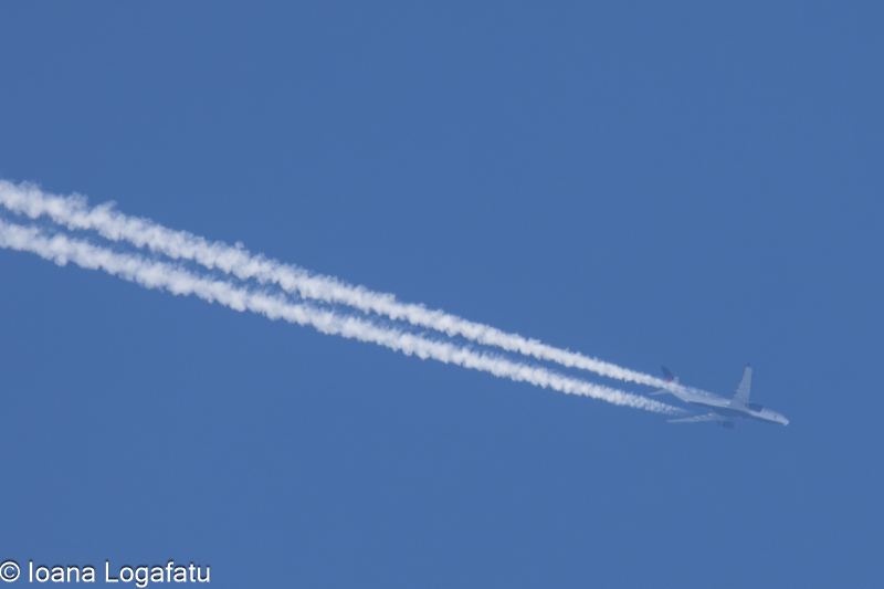 High above the clouds, a jet leaves its mark